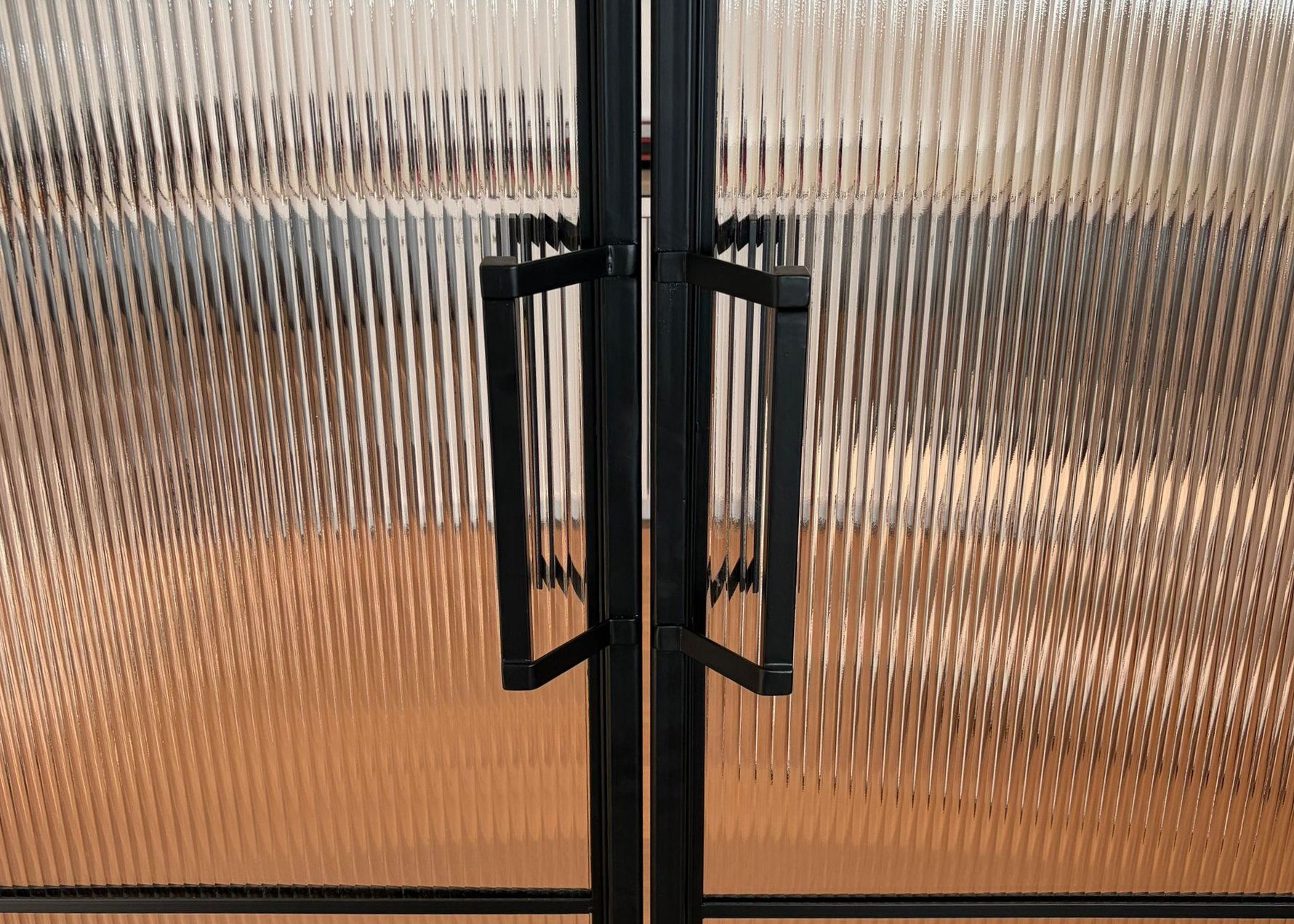 Metal handle on reeded glass door
